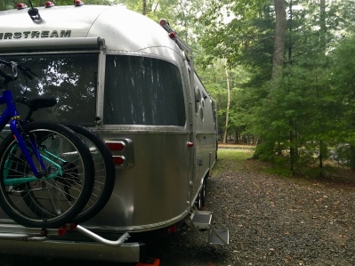 Airstream parked at our wooded campsite